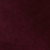 A close-up image of a dark burgundy or maroon textured surface, possibly fabric or a wall, with subtle shading variations.