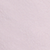 A close-up view of a light pink, textured surface, possibly fabric or paper, with subtle creases and variations in color.