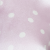 A close-up of a soft, light pink fabric with white polka dots scattered across the surface. The image is slightly out of focus, giving it a gentle and dreamy appearance.