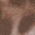 Close-up of a brown and beige patterned surface, possibly resembling animal fur or a textured fabric with irregular, organic shapes and a speckled appearance.