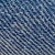 Close-up view of blue denim fabric showing the diagonal weave pattern and texture of the threads.