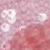 Close-up image of pink and red cells under a microscope, showing a cluster of round, white blood cells and a background of red-stained tissue.