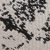 Close-up of two textured surfaces: one light beige with a woven pattern, and one dark gray or black with a ribbed texture, separated by a curved seam.
