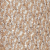 Close-up view of a textured surface covered with numerous sesame seeds scattered densely across a light brown background.