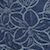 A close-up of a dark blue fabric with a floral pattern outlined in light blue lines.