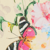A colorful butterfly with black and white striped wings rests on a background featuring pink and blue flowers and green leaves.