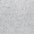 A close-up view of a textured silver glitter surface, sparkling with tiny reflective particles that create a shimmering, festive appearance.