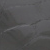 A close-up of a dark, smooth stone surface with subtle lines and textures visible across the rock.