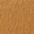 Close-up of a textured orange-brown surface, resembling wood grain or rough fabric with an uneven pattern.