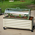 Pacific PC Cloche covering young plants in a cream rolling raised garden bed on a lawn| Vego Garden
