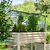 Angled view of a Vego Garden wire cloche over herbs in a white rolling raised bed.| Vego Garden