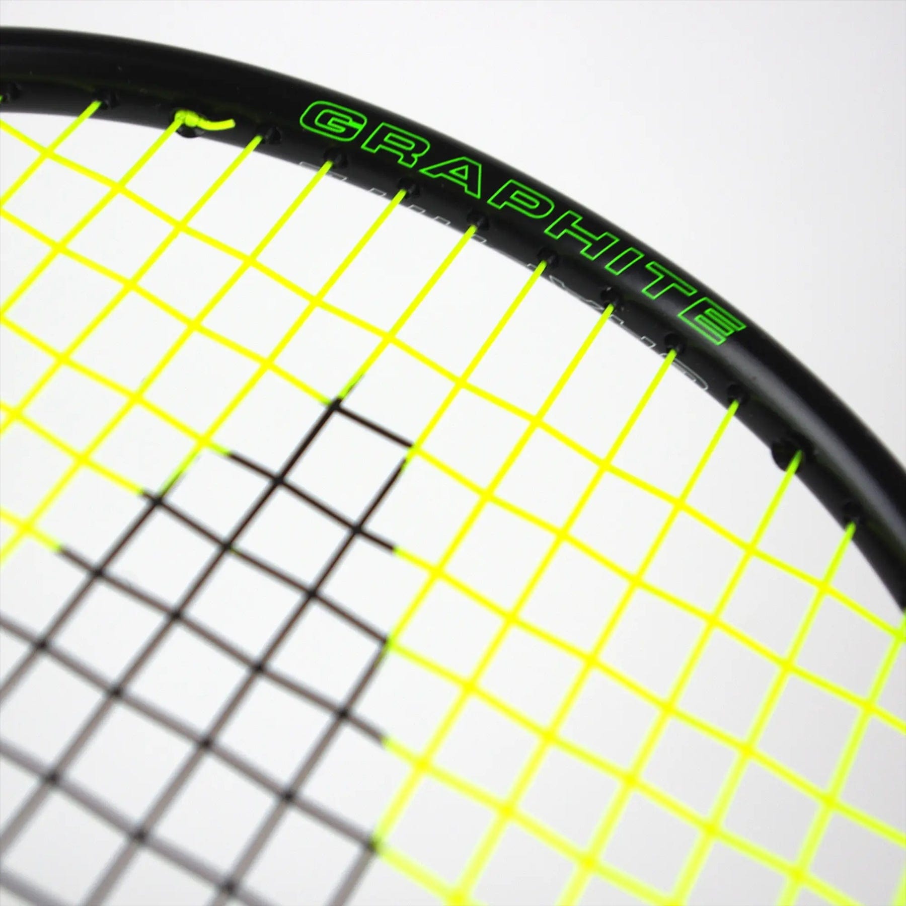 The Karakal Black Zone BZ 20 2.1 Badminton Racket showcases an isometric head with vibrant yellow strings and a sleek black frame. "GRAPHITE" in green adorns the frame, similar to the Karakal BZ 20, and the grid pattern contrasts sharply against its white backdrop.