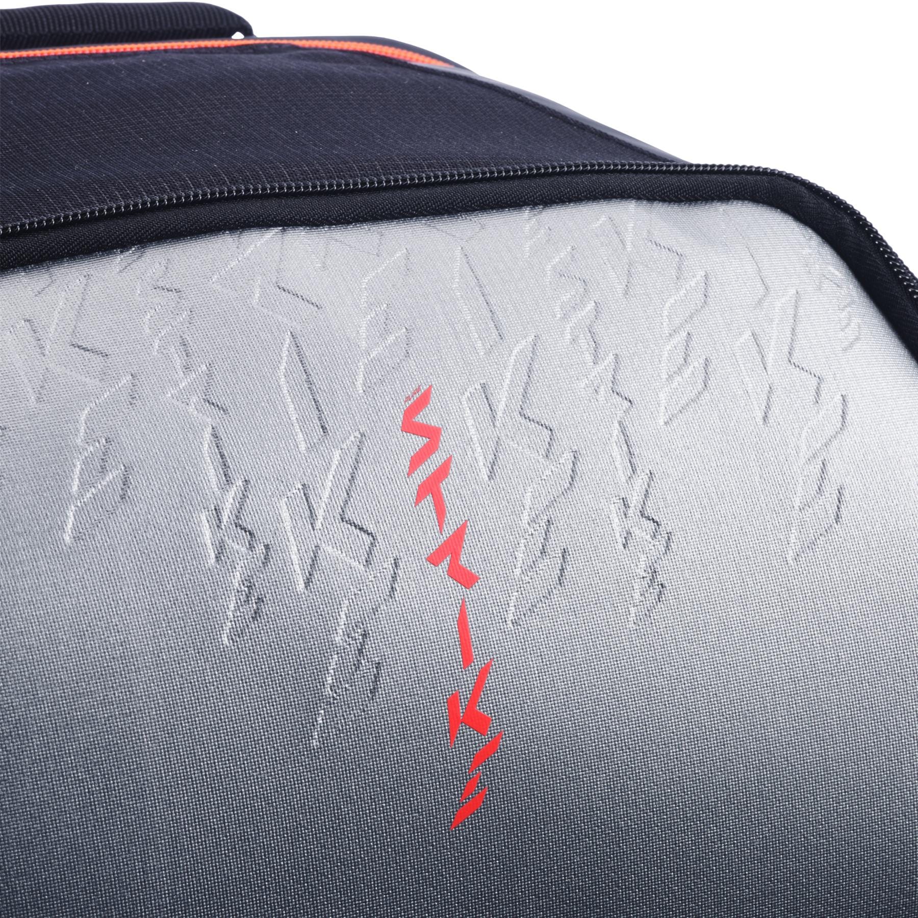 Close-up of the textured carbon grey surface with raised and bold red zigzag lines on the Babolat Pure Strike Tennis Backpack by Babolat.