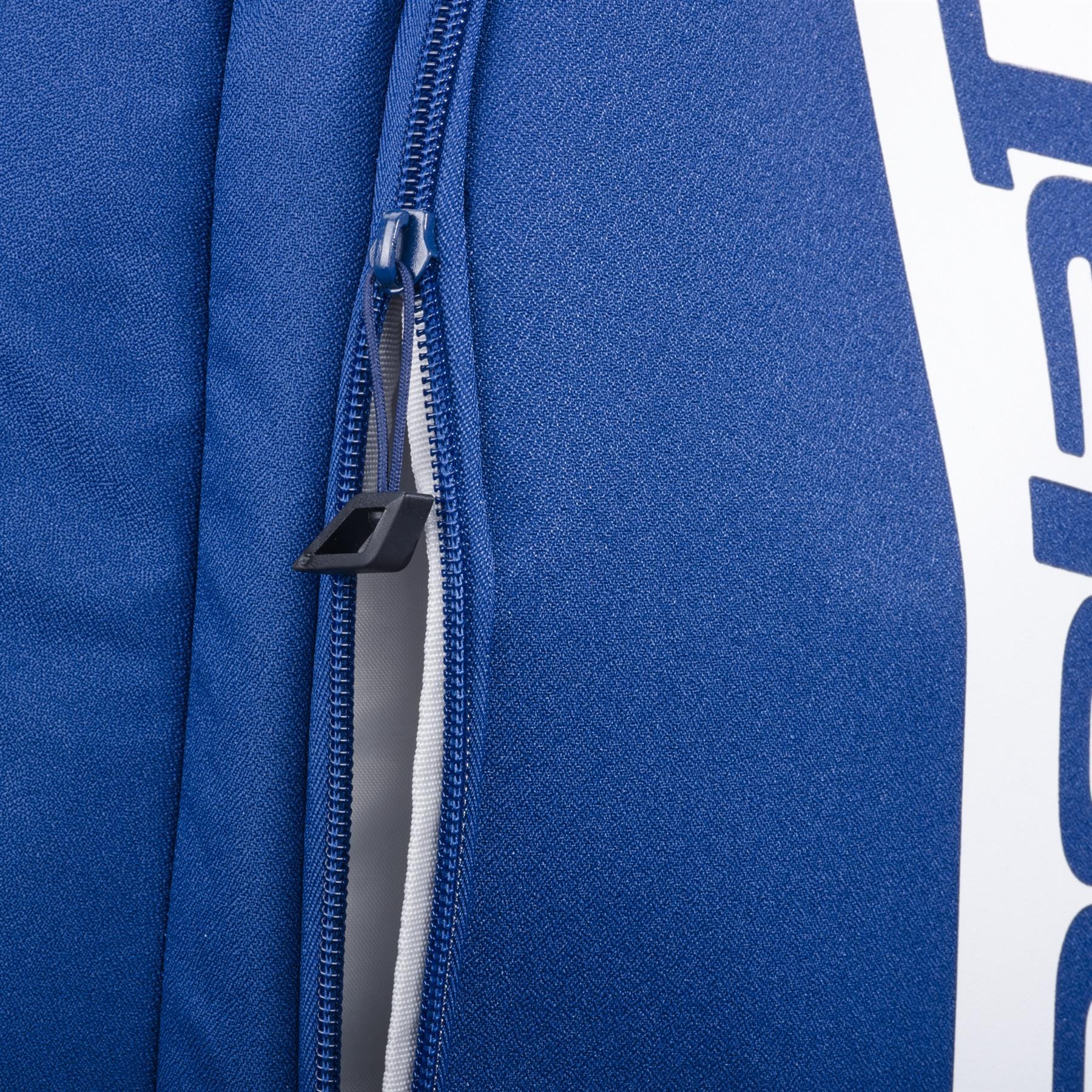 Close-up of the Babolat Court Hero Badminton Backpack - Dark Blue by Babolat, a blue bag made from recycled PET, featuring a visible zipper with black pull tab and partially open to show its white lining and partial white text on the side.