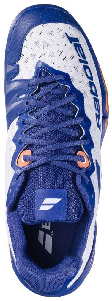 A top view of the Babolat Shadow 4 Men's Badminton Shoes in White, Blue, and Navy by Babolat, featuring blue laces and visible Babolat logos on the tongue and side.