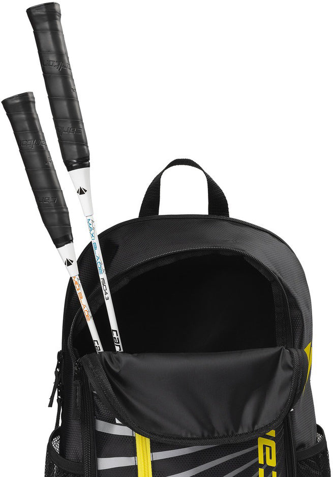 A Carlton Team Badminton Backpack in black and yellow, designed by Carlton as a badminton backpack or racket bag, with two white tennis racquet handles visible from the partially open top compartment.