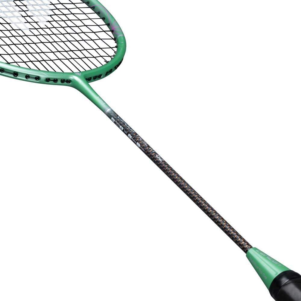 Close-up of the Carlton Vapour Trail HT 82 G6 4U Badminton Racket by Carlton, featuring a green design with a black grip and carbon fiber shaft, ideal for advanced players, highlighting the strings and part of the handle against a white background.