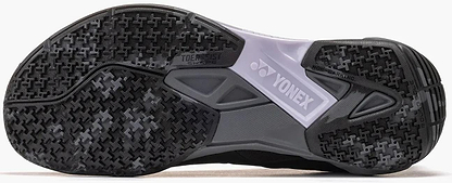 Close-up of the sole of Yonex Power Cushion Cascade Drive 3 Unisex Badminton Shoes in black/grey, featuring a textured grip pattern, Yonex logo, and "TOE ASSIST SHAPE" and "NON MARKING" markings.