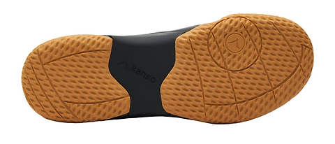 The image displays the sole of the Kanso Equilibrium EQx3 unisex badminton shoe in black, featuring a textured rubber material with a waffle-like tread for grip. Enhanced with Speedlight foam, the light brown sole showcases a "Kanso EQX3" label at its center.