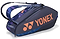 The Yonex 92426EX 6 Racket Pro Tennis Bag in Midnight Navy holds up to 6 rackets and features two shoulder straps for easy carrying, with a bold orange logo and geometric blue accents for a sporty look.