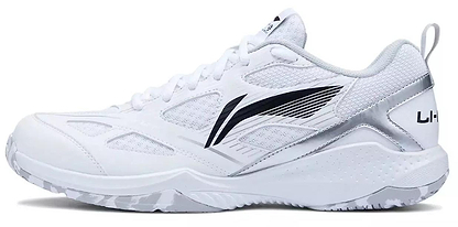 The Li-Ning Blast JF-01 Lite Unisex Badminton Shoes in white feature silver accents, a black swoosh-style design, mesh panels, textured soles for performance on court, and the Li-Ning brand name on the heel.