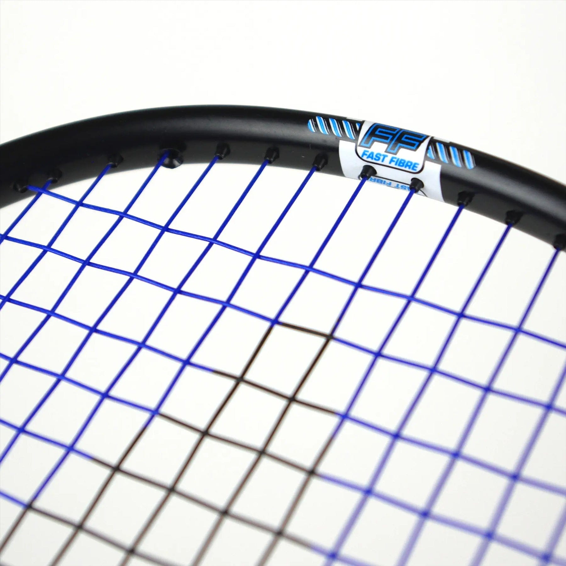 Close-up of a Karakal Black Zone BZ 50 2.1 badminton racket head with tightly-strung blue strings. The black frame, crafted from Fast Fibre Graphite, features an "Isometric square head" label. The image highlights the string pattern and part of the frame against a plain white background.