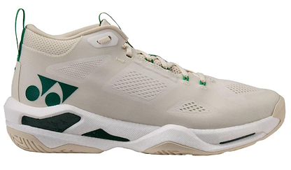 The Yonex Power Cushion GRPHT THRTTL Concept men's badminton shoe features a beige mid-top design with green accents, mesh panels for breathability, a stylized side logo, and a textured sole.