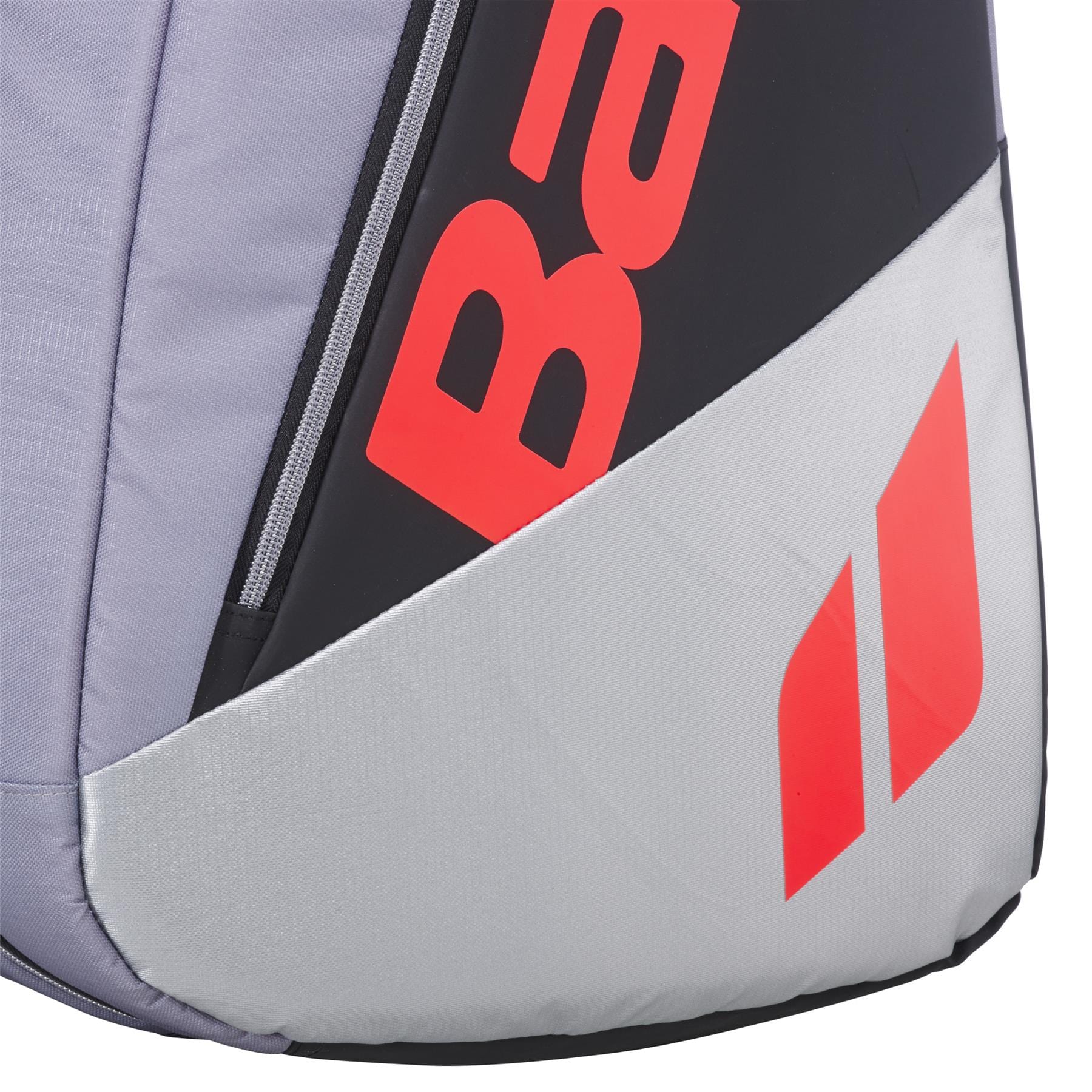Close-up of the Babolat RH9 Pure Strike 9 Racket Tennis Bag in Carbon Grey, featuring a large red logo on black and grey water-repellent material, a red geometric pattern on light grey, and a visible zipper along the black panel.