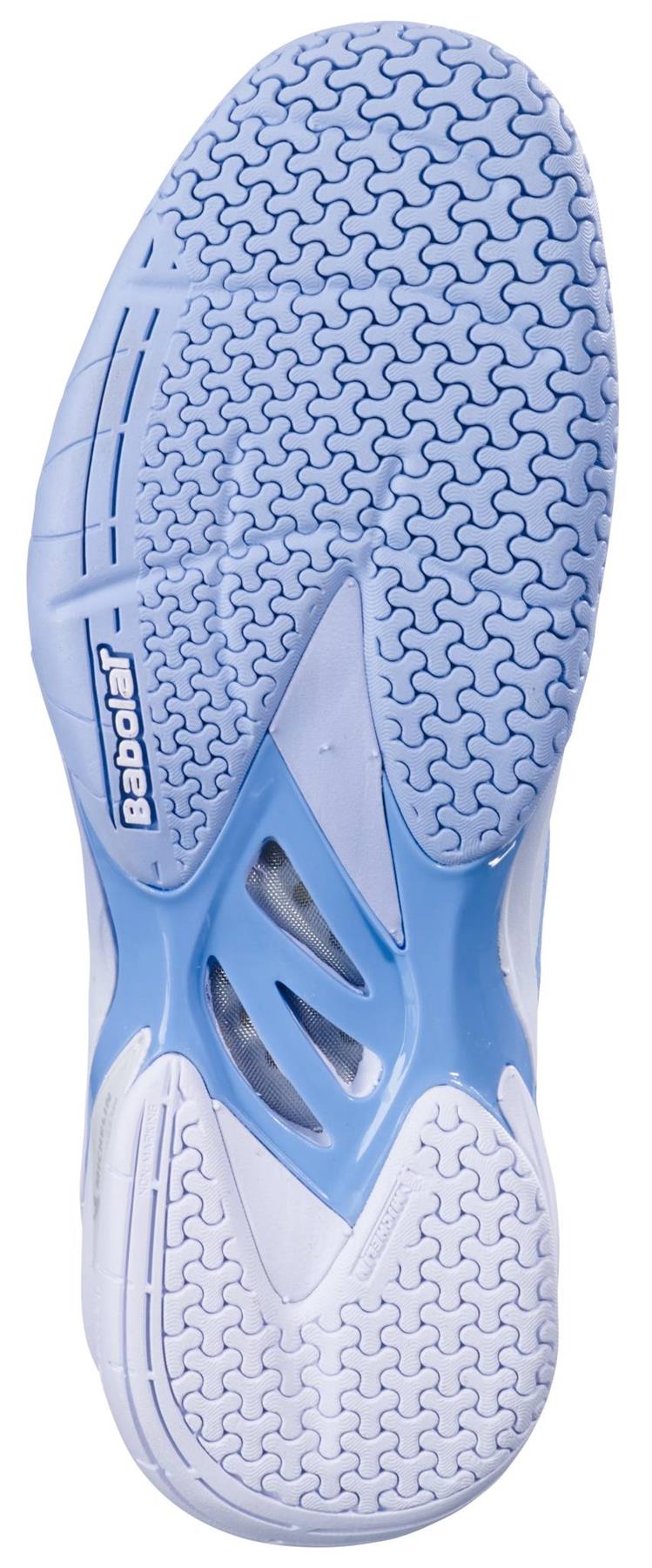 The image displays the light blue and white sole of the Babolat Shadow 4 Womens Badminton Shoes - Snow Blue, featuring a textured zigzag pattern for traction with “Babolat” embossed near the heel.