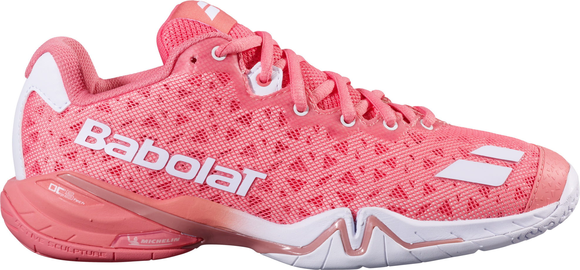 The Babolat Shadow 4 Women's Badminton Shoes in Shell Pink and White feature a white logo, patterned texture, and contrasting white accents. Designed for advanced players, these lace-up shoes provide exceptional stability with a thick sole and display Michelin branding near the heel.