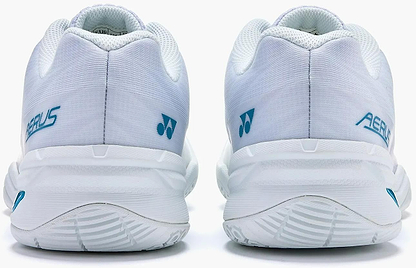 The Yonex Power Cushion Aerus X2 Unisex Badminton Shoes in White/Blue feature light blue branding and textured soles, shown from the back. These lightweight indoor court shoes offer a clean design with minimal detailing.