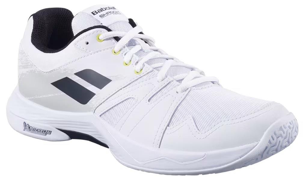 The Babolat Shadow Team 2 Men's Badminton Shoes in White feature black and gray accents, a lace-up design, textured indoor court sole, and Babolat logos on the side and heel.
