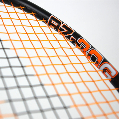 Close-up of a tennis racket with black and orange strings, capturing the tension similar to a Karakal Black Zone BZ 30 2.1 badminton racket. The frame reads "RZ 30C" in bold orange and white, highlighting the string pattern under soft lighting.