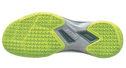 The image shows the sole of Yonex Power Cushion 65X4 Viktor Axelsen Badminton Shoes (White/Lime) with a bright lime tread and cross pattern for grip. The gray midsection has "Yonex" and "Ergoshape" branding.