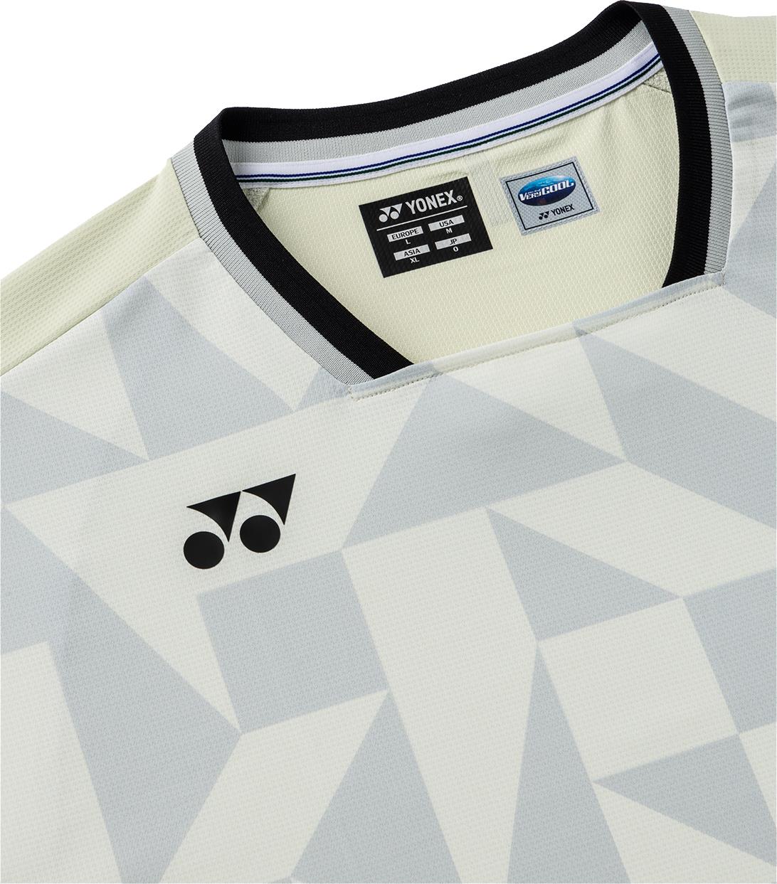 A close-up of the Yonex 10712YX Crew Neck Men's Badminton T-Shirt in Champagne, featuring a geometric gray and white design, black Yonex logo on the chest, quick-drying fabric, and visible collar tags for style and performance.