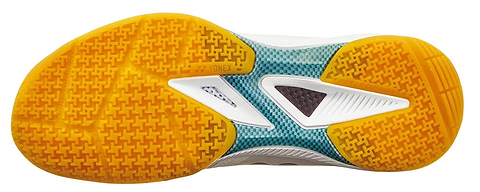 The image shows the sole of Yonex Power Cushion 65Z4 Men's Badminton Shoes in white, with a yellow textured grip, teal midfoot accents, white geometric details, and the Yonex logo at the center—ideal for advanced players.