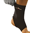 A person wearing a Precision Neoprene Ankle Support, featuring the "Precision" branding, adjusts the snug brace that encases the ankle like a compression sleeve. Offering stability while leaving the toes exposed, it is ideal for recovering from ankle sprains.