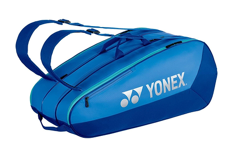 The Yonex 42529EX Team 9 Racket Badminton Bag in Blast Blue features two shoulder straps, a zippered compartment for sports gear, and an aerodynamic design. The Yonex logo is prominently displayed, making it perfect for athletes.