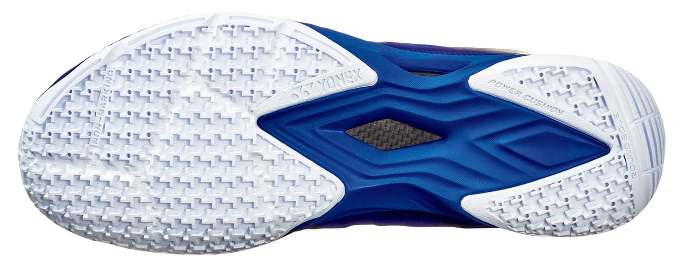 The picture features the sole of Yonex Power Cushion Aerus Z2 Men's Badminton Shoes in navy blue, highlighting a mainly white textured design with a unique blue Power Cushion section for grip and stability.
