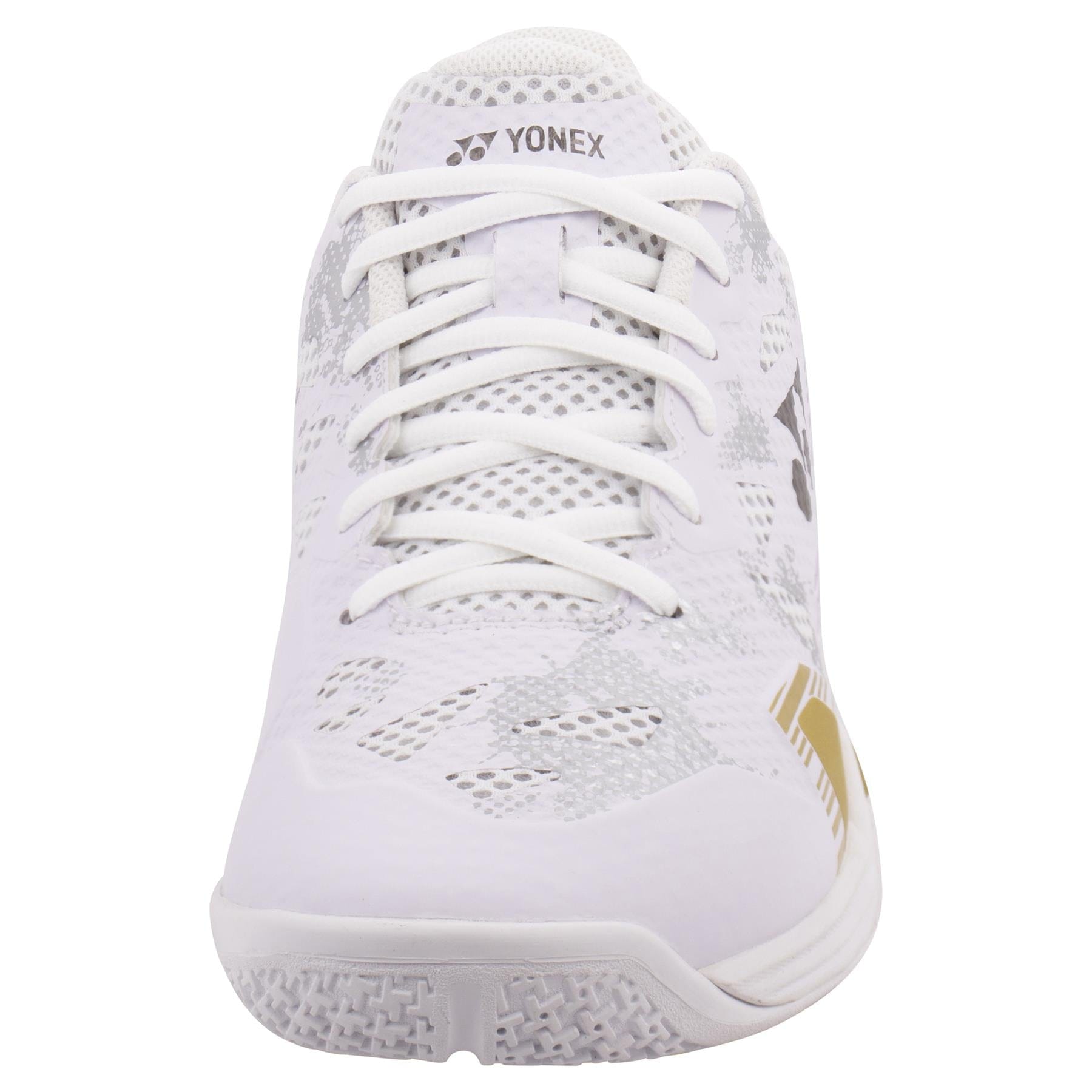 The Yonex Power Cushion Eclipsion Z3 Men's Badminton Shoes showcase a breathable white mesh design, featuring white laces, subtle gray patterns, and a gold accent. The shoe incorporates Yonex's Power Cushion technology for excellent cushioning and repulsion, while the textured sole ensures grip.