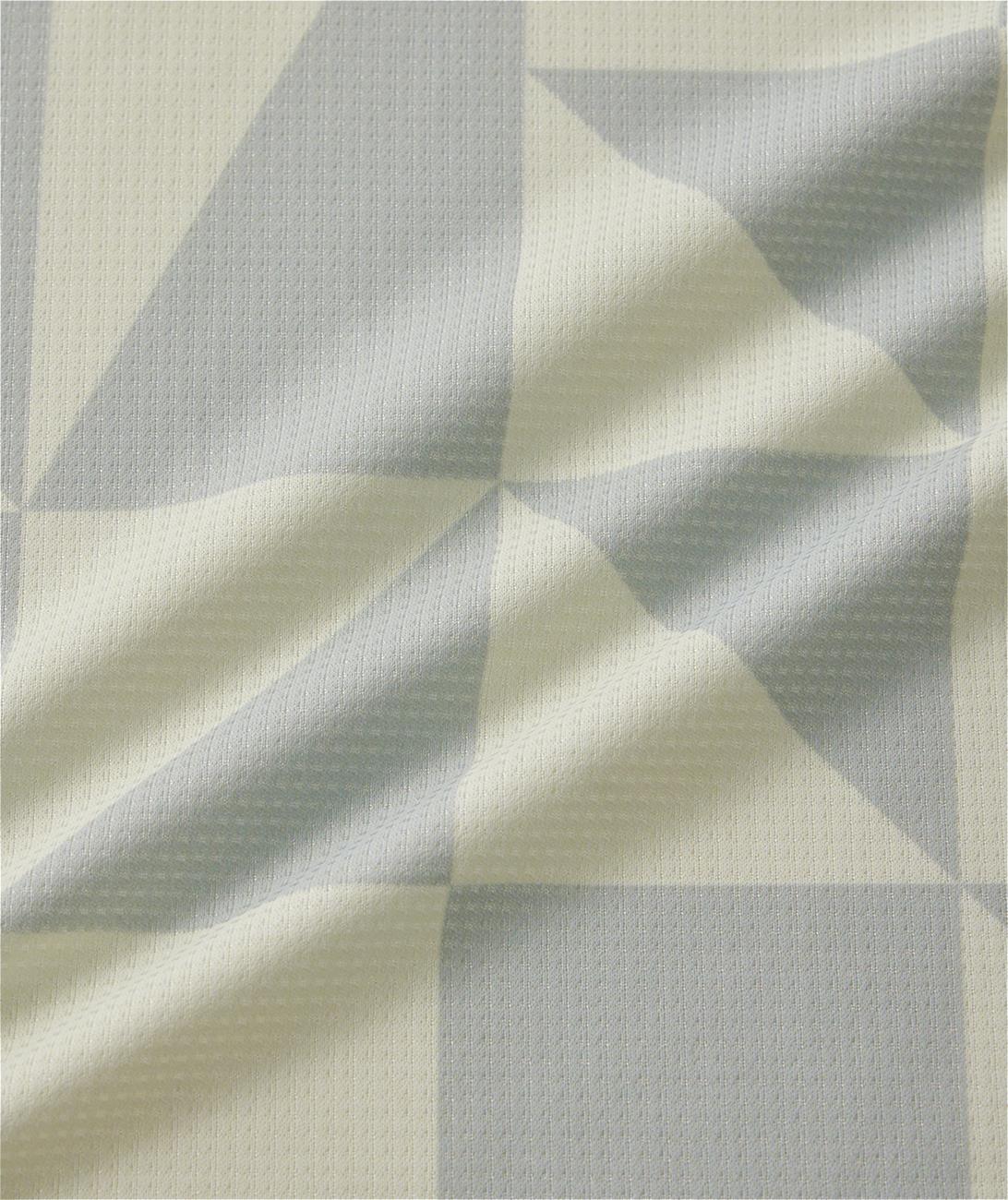Light grey and off-white geometric patterned fabric with gentle folds, ideal for the Yonex 10712YX Crew Neck Men’s Badminton T-Shirt in Champagne—quick-drying, comfortable, and perfect for modern performance.