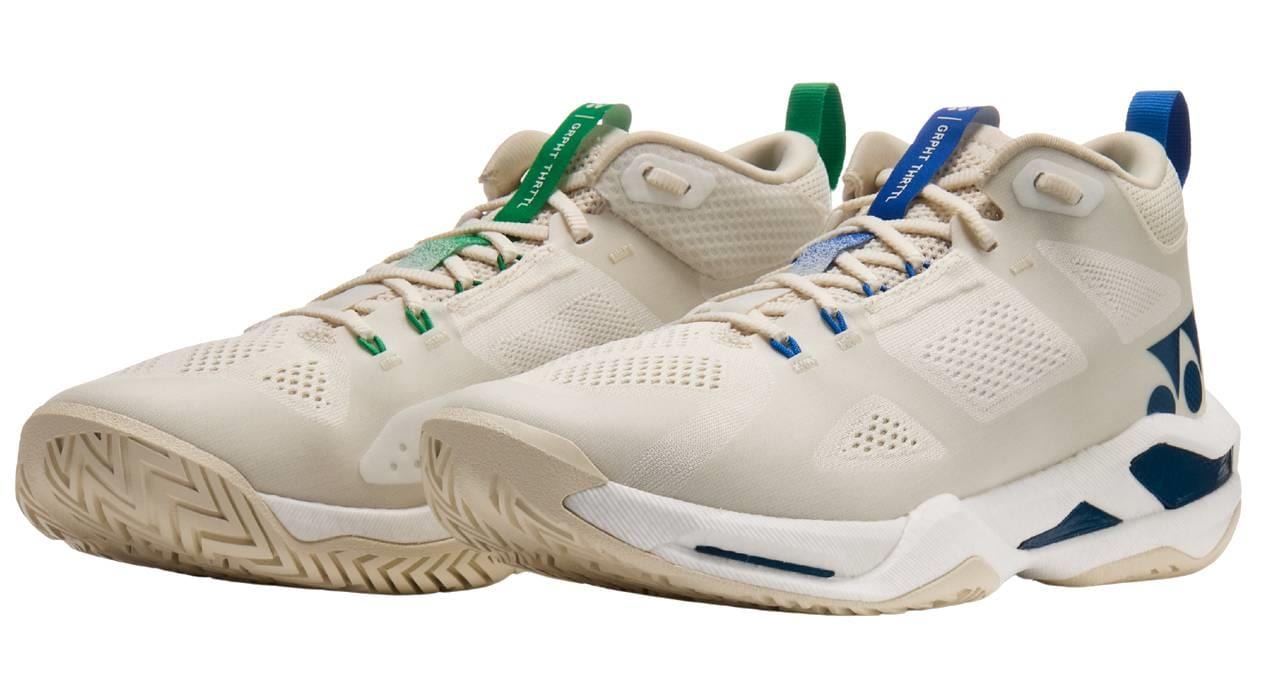 Yonex Power Cushion GRPHT THRTTL Concept men’s badminton shoes feature beige mesh uppers, blue and green accents on the tongue and heel, blue side and sole details, and a modern chunky design.
