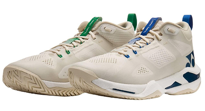 Yonex Power Cushion GRPHT THRTTL Concept men’s badminton shoes feature beige mesh uppers, blue and green accents on the tongue and heel, blue side and sole details, and a modern chunky design.