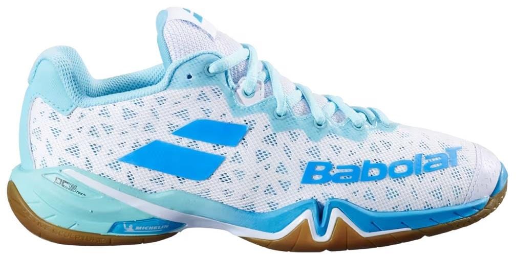 The Babolat Shadow 4 Women’s Badminton Shoes in White Lagoon feature a mesh upper, light blue accents, blue logo details, and a light brown rubber sole.