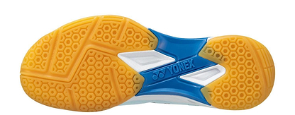 The image shows the sole of Yonex Power Cushion Eclipsion X3 Unisex Badminton Shoes in light blue, featuring a yellow honeycomb tread, blue midsection, and white accents—designed for indoor courts with Yonex’s Power Cushion technology.