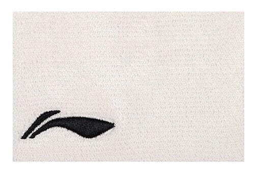 A white towel with a textured surface has a small black embroidered logo of a stylized shoe or wing in the lower left corner, similar to the sleek design of the Li-Ning Corner Logo Wristband - White by Li-Ning.