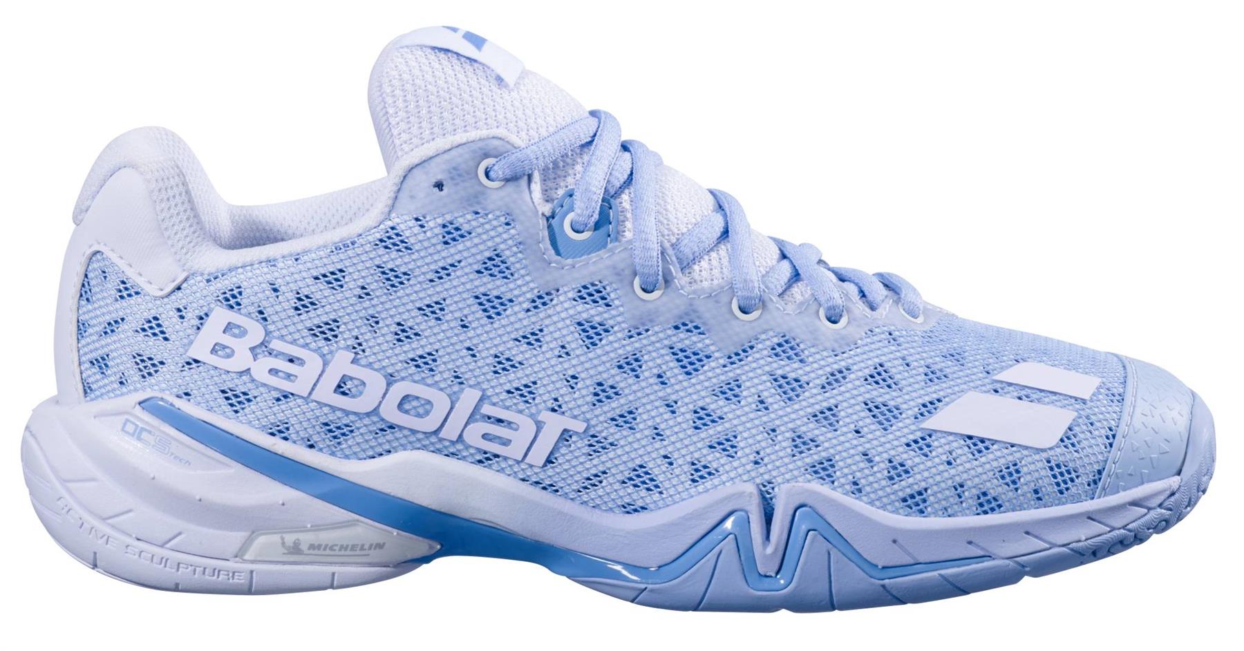 The Babolat Shadow 4 Womens Badminton Shoes - Snow Blue feature a light blue and white mesh upper, branded side logo, and patterned sole designed for athletic performance.