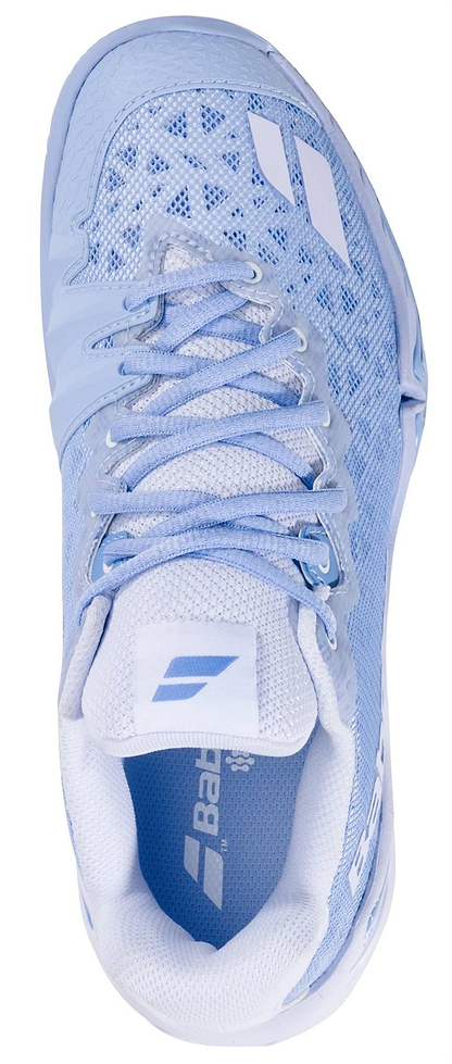 A top-down view of the Babolat Shadow 4 Womens Badminton Shoes - Snow Blue by Babolat, showing light blue mesh fabric, white laces, geometric upper patterns, and branded logos on the tongue and side.