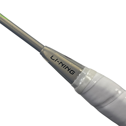 Close-up of the Li-Ning Halbertec 9000 Power Badminton Racket in Black/Silver, featuring a high-performance shaft with the "LI-NING" logo and a white-wrapped grip, highlighting its quality craftsmanship.