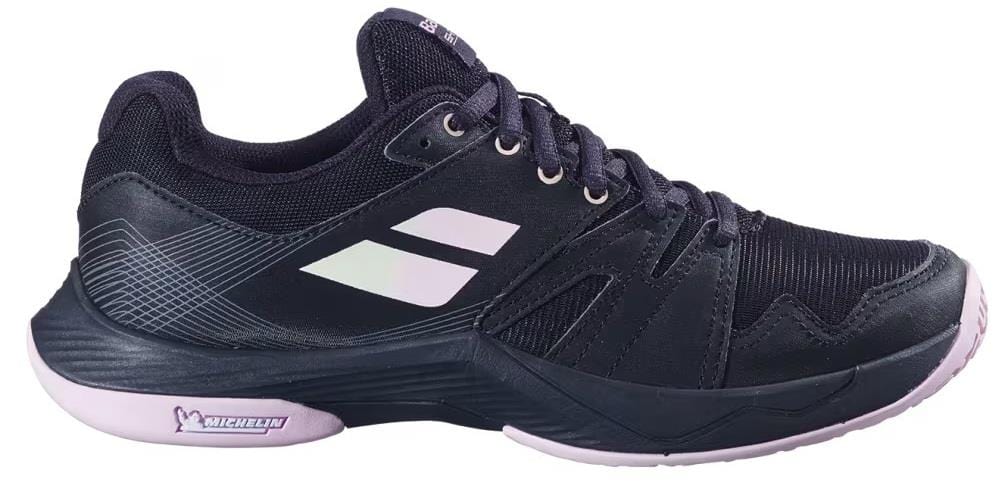 The Babolat Shadow Team 2 Women's Badminton Shoes in black feature white accents, a light pink sole, and the Michelin logo on the heel—making them an excellent choice for indoor courts.